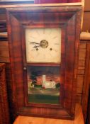 A late 19th century American wall clock with striking movement, a pine four-shelf plate rack,