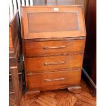A mid 20th century oak bureau, the interior fitted with pigeonholes, three drawers below,