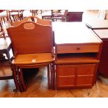 A Parker Knoll teak nest of three side tables, the cupboard with frieze drawer,