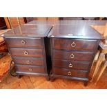 A pair of Stag furniture bedside chests of four long drawers on bracket feet,
