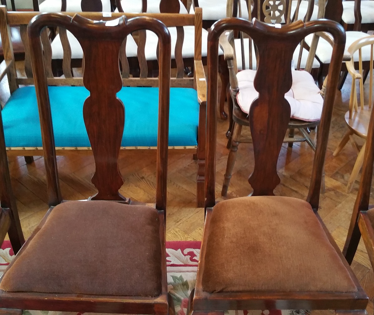 A set of four mahogany reproduction Queen Anne style dining chairs with solid vase shaped splats