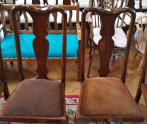 A set of four mahogany reproduction Queen Anne style dining chairs with solid vase shaped splats