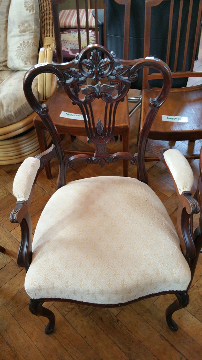 An early 20th century mahogany framed tub shaped dressing stool with finely turned stretchers and