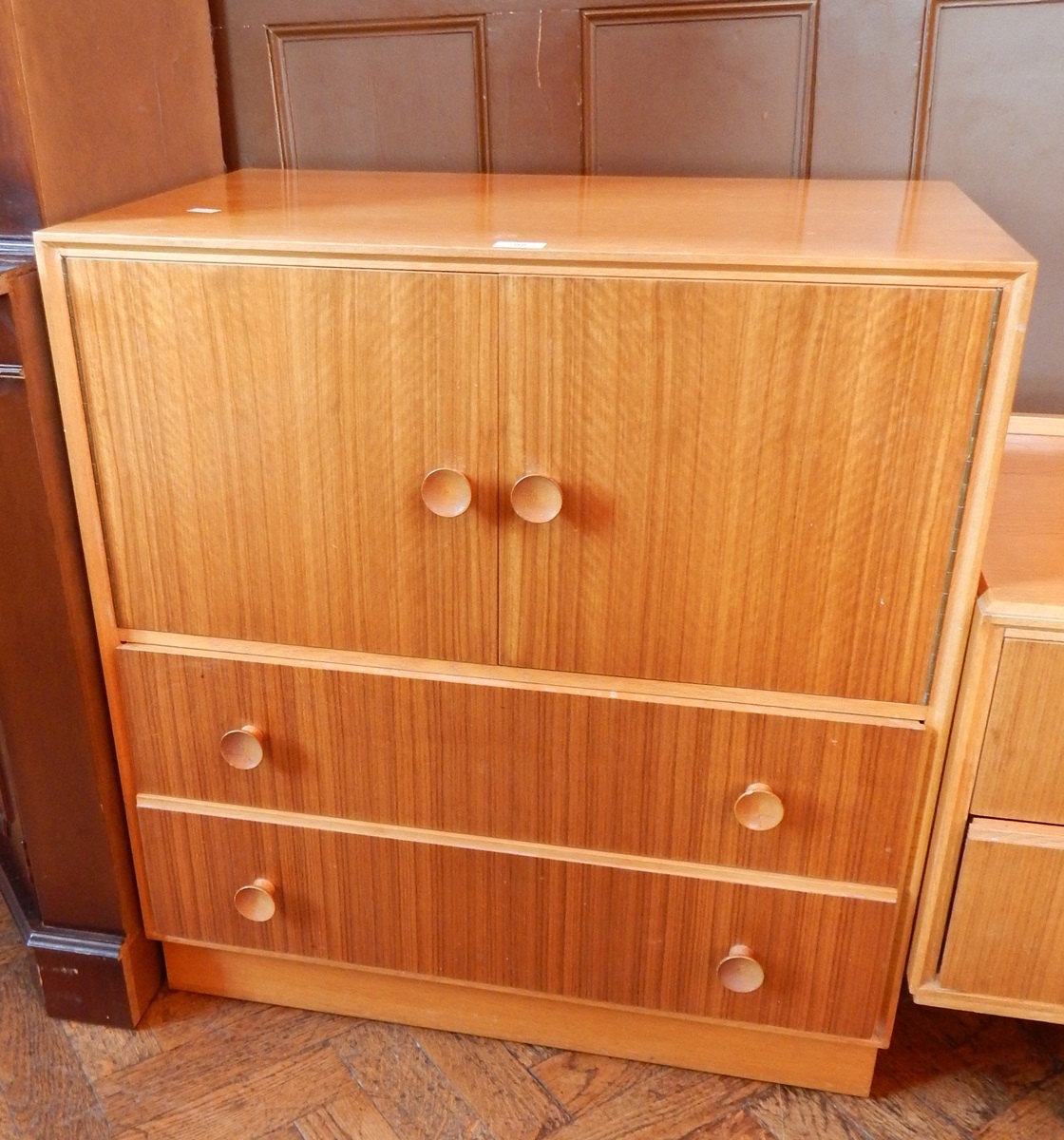 A modern teak/oak mirror back dressing chest of four short drawers,