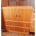 A modern teak/oak mirror back dressing chest of four short drawers,