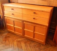 A contemporary teak chest of four short drawers with pair panelled cupboard doors below,