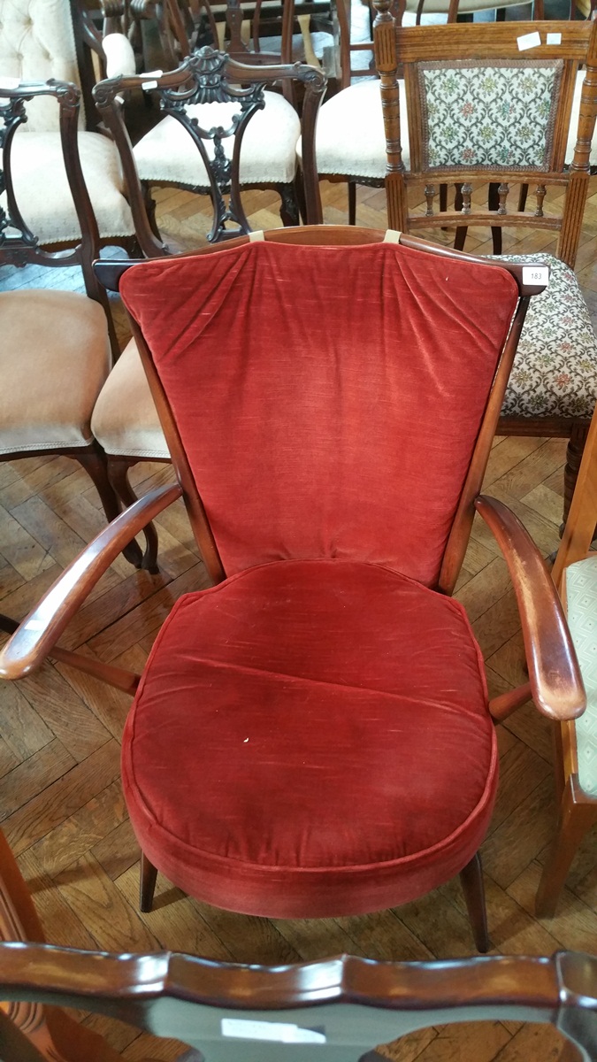 An Ercol style open arm stickback elbow chair