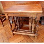 A nest of three oak occasional tables, on turned legs,