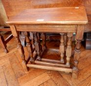 A nest of three oak occasional tables, on turned legs,