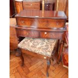 A reproduction mahogany desk, the writing front enclosing a fitted interior with writing surface,