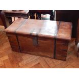 An Indian hardwood trunk with side carrying handles, ironwork strapwork,