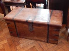 An Indian hardwood trunk with side carrying handles, ironwork strapwork,
