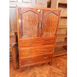 A mahogany gentleman's cabinet with pair of panelled doors and three long drawers below,