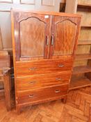 A mahogany gentleman's cabinet with pair of panelled doors and three long drawers below,