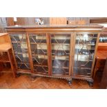 A mahogany Chippendale style breakfront bookcase, with carved foliate border, cushion frieze,