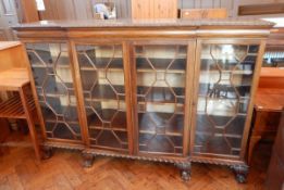 A mahogany Chippendale style breakfront bookcase, with carved foliate border, cushion frieze,