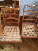 A pair of cane seated ladderback bedroom chairs
