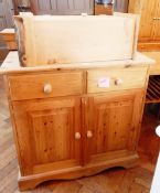 A pine cupboard with two frieze drawers,