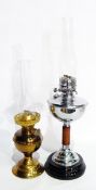 A chrome and treen oil lamp on ceramic base and another brass oil lamp