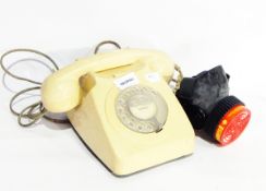 A vintage cream bakelite telephone, a framed display of stamps including a penny black,