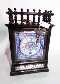 An Edwardian ebonised mantel clock with turned spindle gallery and blue ceramic dial,