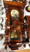 A late Victorian Vienna-style wall clock, the pediment with carved eagle finial, turned finials,