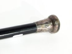 An ebonised walking stick with silver engraved finial