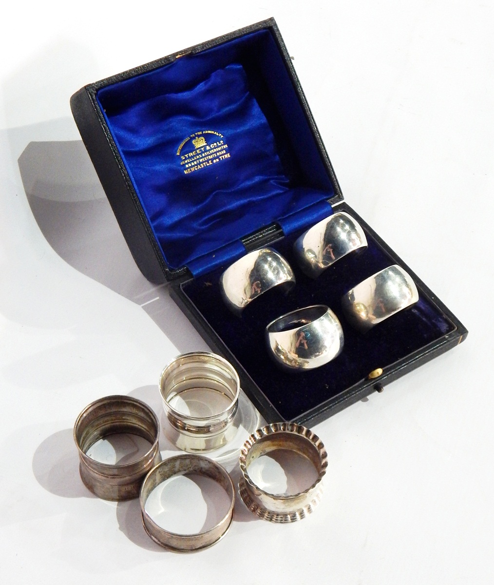 A cased set of four silver napkin rings of plain form,