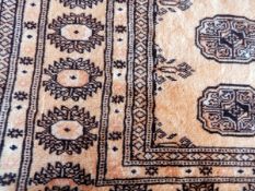 A Chinese wool rug on cream ground with geometric pattern,