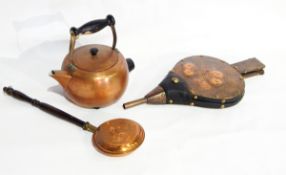 A large collection of metalware including copper bellows,