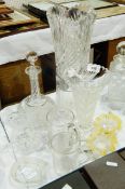 A tall cut glass flower vase, a trumpet-shaped flower vase, tall neck decanter, milk jug,