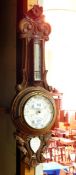 An Edwardian oak aneroid barometer with thermometer,