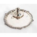 An Egyptian silver tray of shaped circular form and an Egyptian silver chamber stick (af) (2)