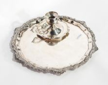 An Egyptian silver tray of shaped circular form and an Egyptian silver chamber stick (af) (2)