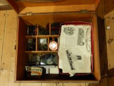 A wooden box of various pieces of Meccano to include cogs, wheels, etc.