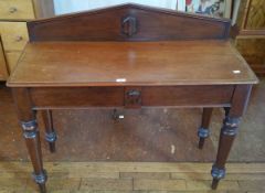 A Victorian mahogany side table, with panelled gallery back, moulded edge top,
