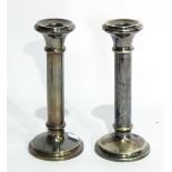 A pair of silver plated candlesticks of plain cylindrical form