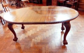 A Chippendale style mahogany wind-out dining table with rounded ends, gadrooned border,