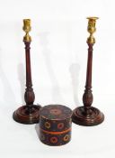 A pair of mahogany turned table lamps, a pair of treen and brass candlesticks,