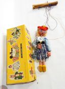 A Pelham puppet of a girl in a red felt cap,