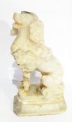 A carved hardstone model of a seated poodle on plinth,