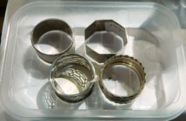 Three silver napkin rings and one other