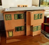 A large doll's house opening to the front together with small doll's furniture and electrical wires,