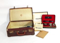 A suitcase and contents of assorted coins, cigarette card albums and a photograph of HMS Avenger,