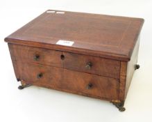 A mahogany sewing box with hinged cover revealing a fitted interior,