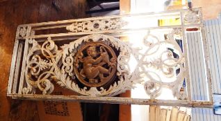 A pair of French cast iron panels showing acanthus with a drinking cherub in the centre