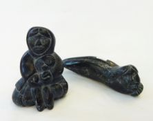 Two Canadian inuit-style hardstone carvings, one of a seated figure with fish,