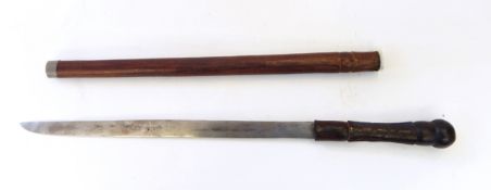 A tribal dagger, the wooden handle with carved geometric decoration and with wooden sheath,