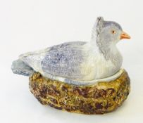A continental pottery majolica game pie dish in the form of bird seated on nest,