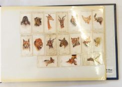 A quantity of cigarette cards including Players "Wild Animals Heads", "Butterflies", etc.